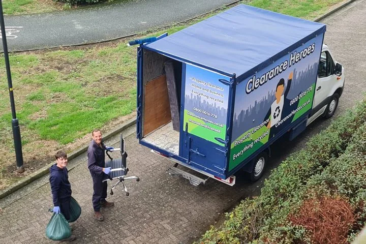 Clearance heroes team carrying items to van