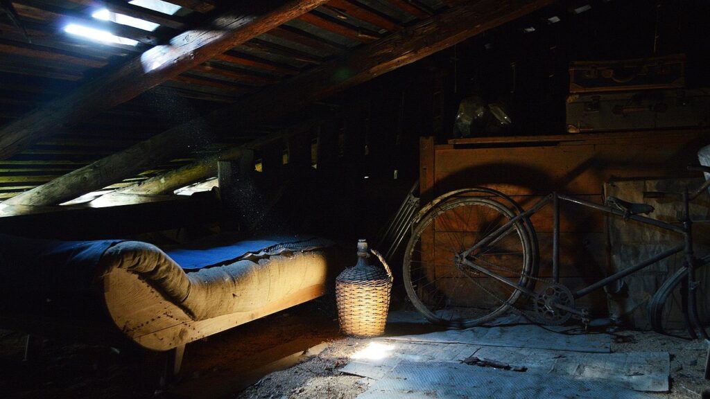 Dusty cluttered attic before a loft clearance